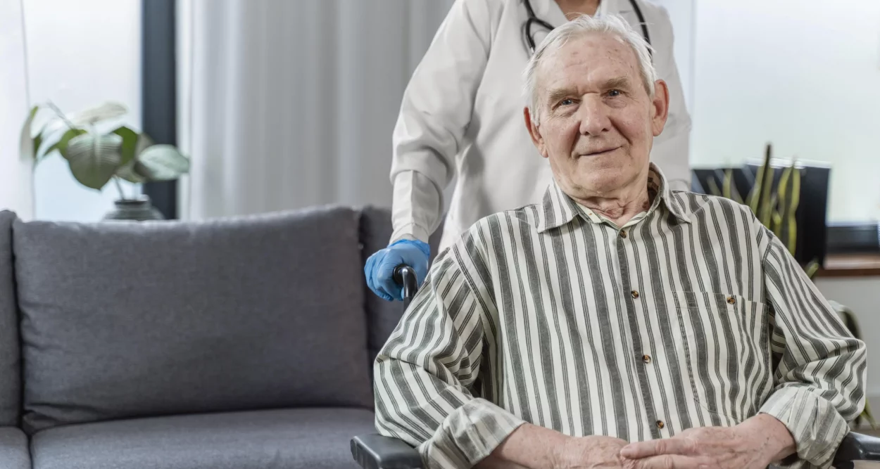 senior-man-sitting-in-wheelchair-next-to-a-doctor